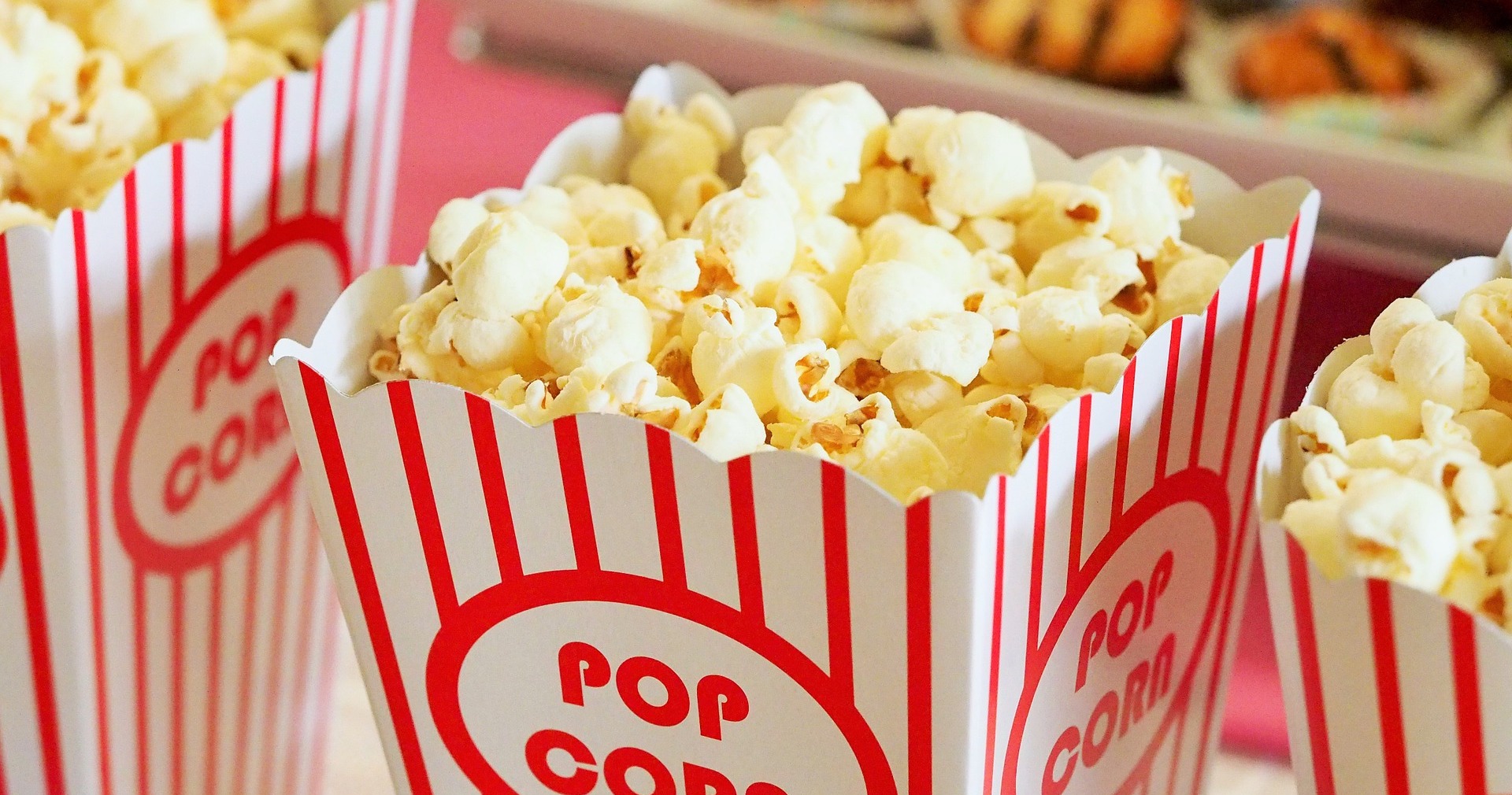 Some cinema-style popcorn in a red and white striped carton