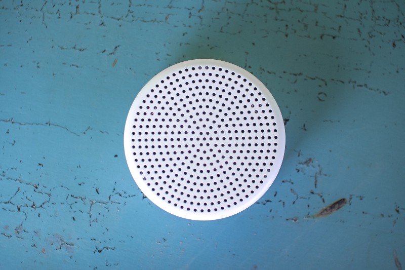 The Point sensor device, which looks like a small white smoke detector-sized disk.