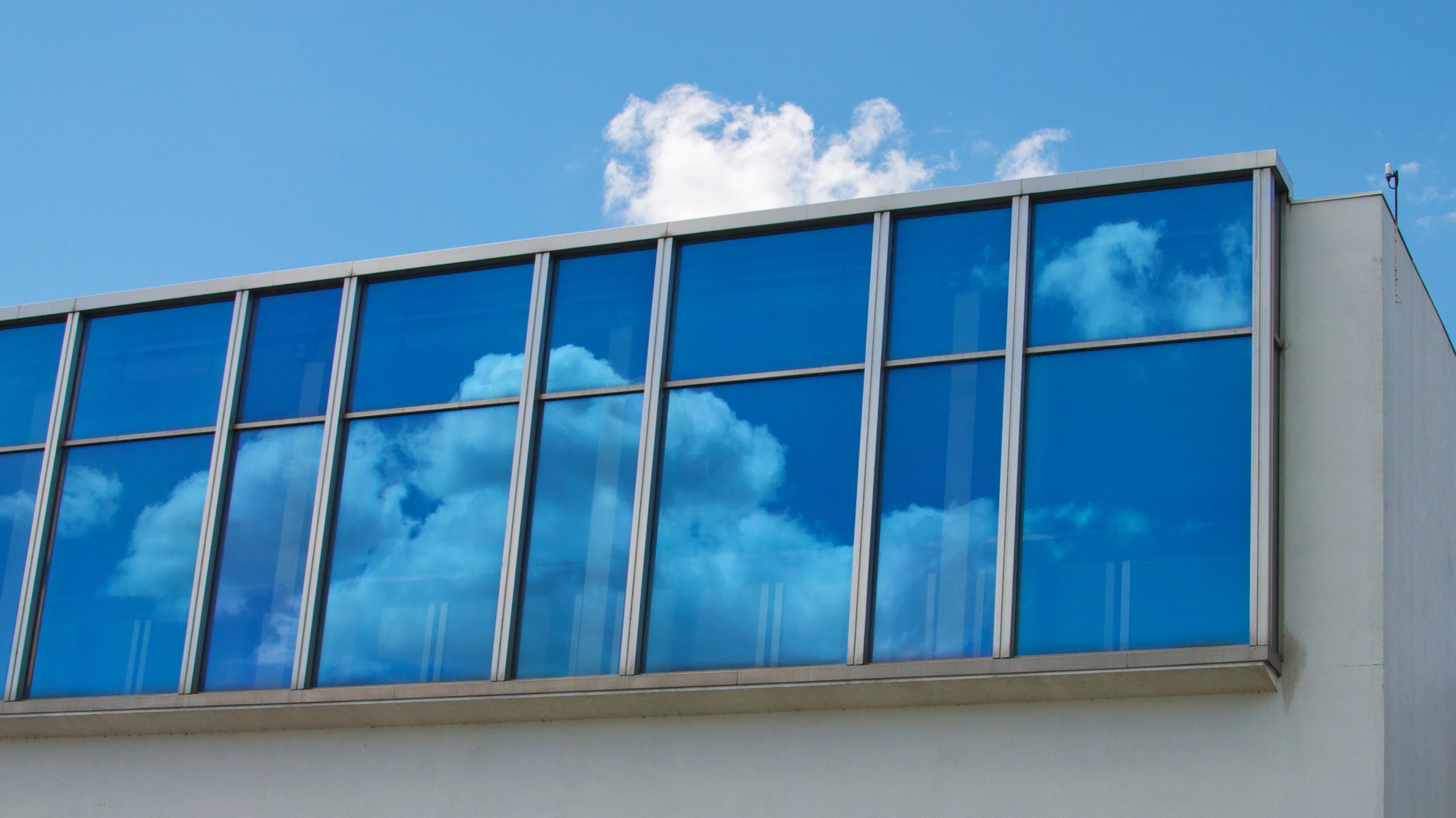Clouds reflected in the windows of an office.